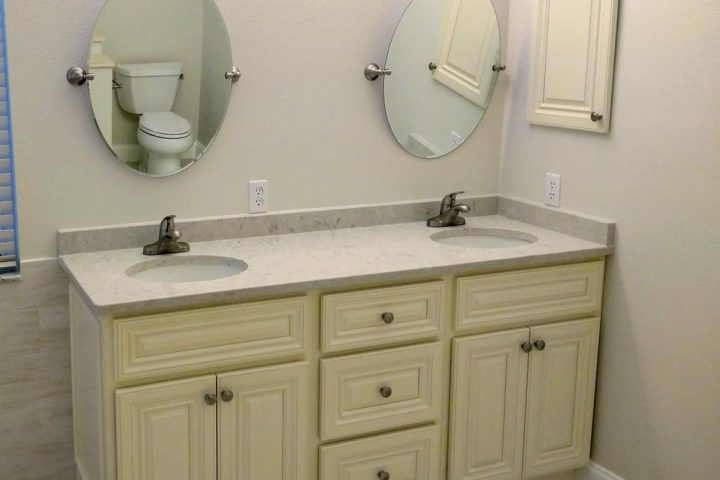 double vanity of a remodeled bathroom with newly installed cabinets with signature pearl door designs