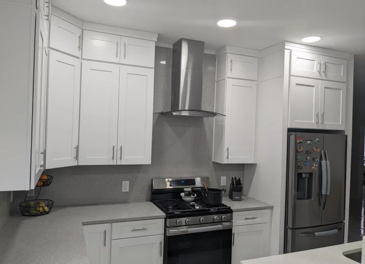 elegant looking kitchen, range with roof, ice white shaker cabinet door installed